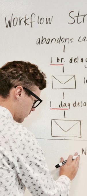 man writing on whiteboard